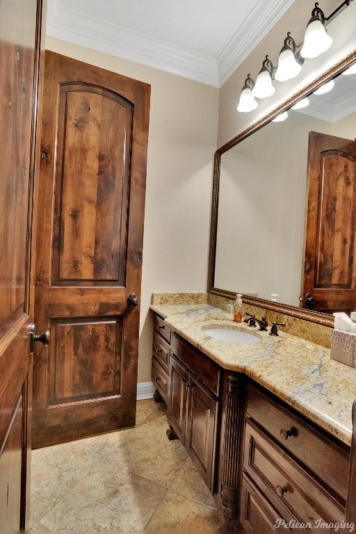 bathroom with ornamental molding, tile floors, and vanity