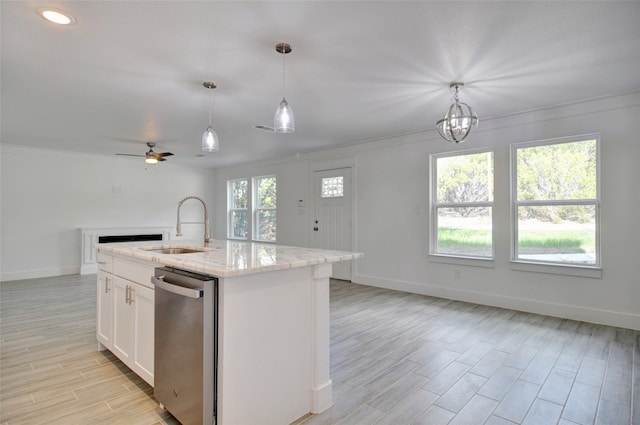 kitchen with decorative light fixtures, white cabinets, stainless steel dishwasher, a kitchen island with sink, and ceiling fan with notable chandelier