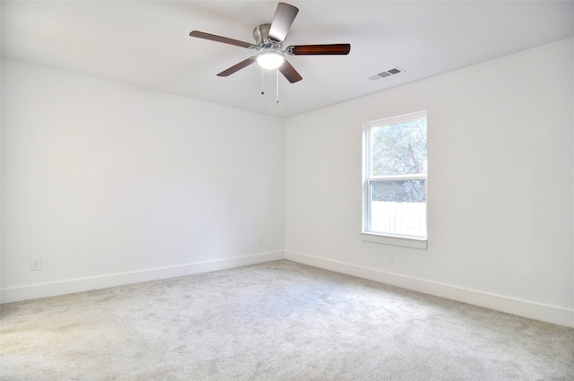 empty room featuring light carpet and ceiling fan