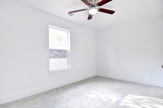 spare room featuring plenty of natural light, light colored carpet, and ceiling fan