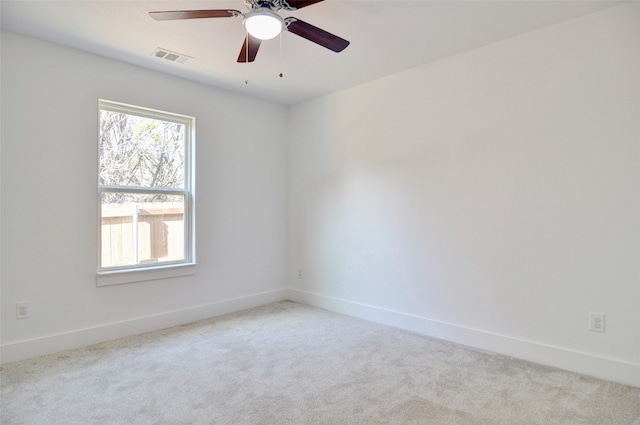 carpeted empty room with plenty of natural light and ceiling fan