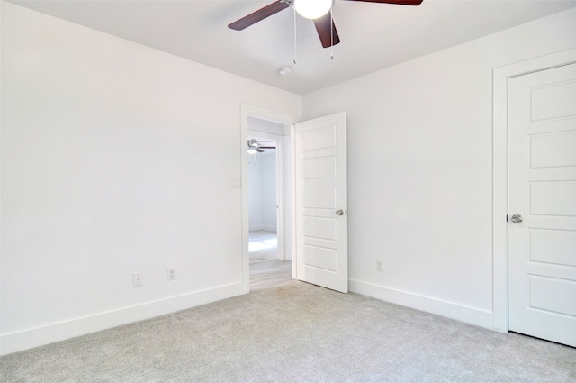 unfurnished room with ceiling fan and light colored carpet