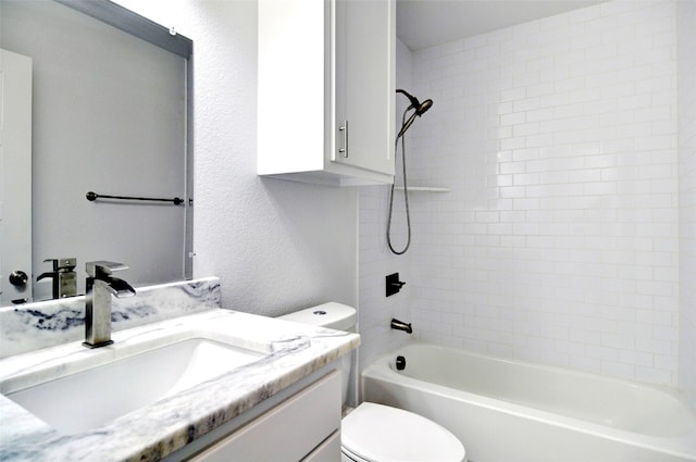 full bathroom with toilet, vanity, and tiled shower / bath combo