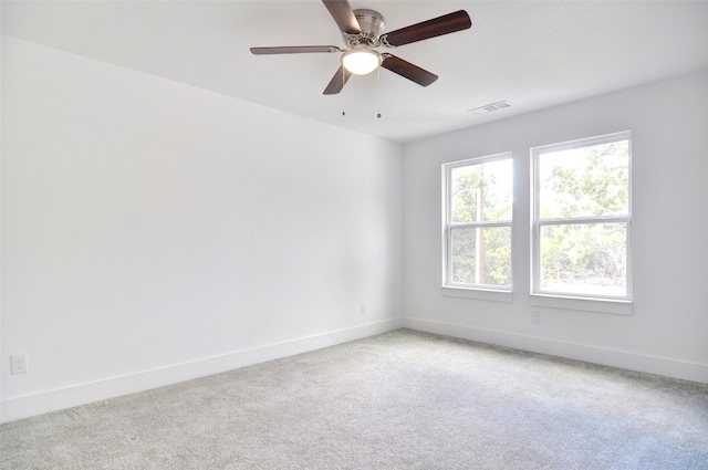 empty room with light colored carpet and ceiling fan