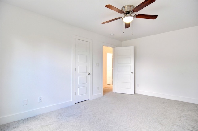 unfurnished bedroom with light colored carpet and ceiling fan