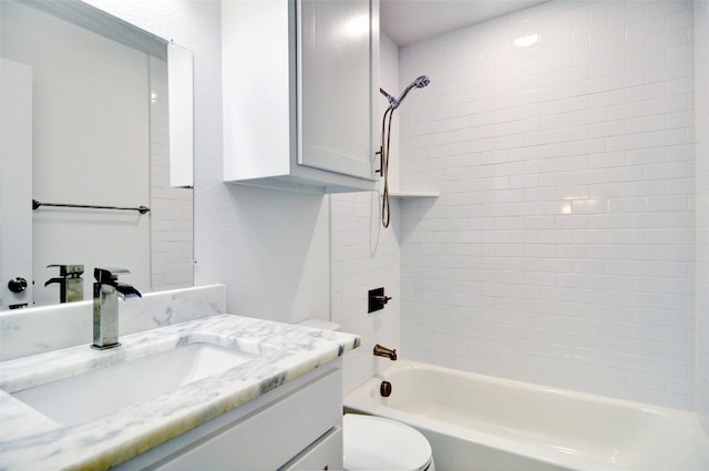 full bathroom with oversized vanity, toilet, and tiled shower / bath