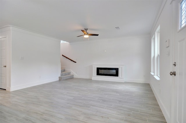 unfurnished living room with light wood-type flooring, ceiling fan, and ornamental molding