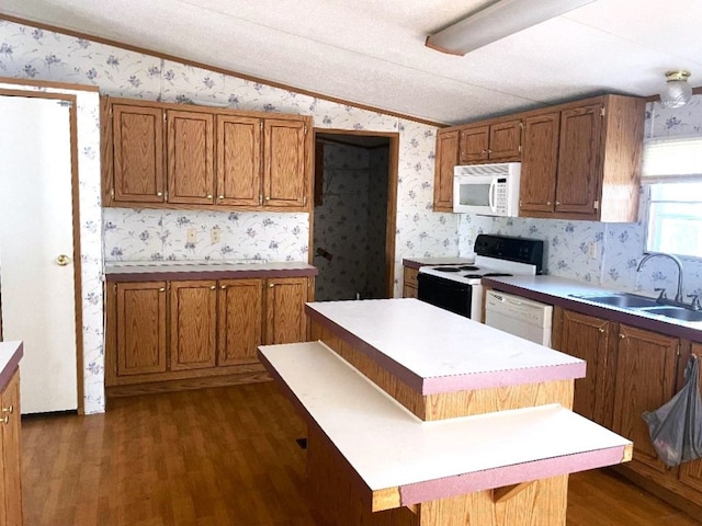 kitchen featuring crown molding, sink, white appliances, and dark wood-type flooring