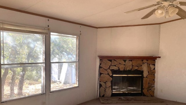 living room featuring a fireplace, a healthy amount of sunlight, and ceiling fan