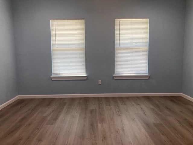 spare room with wood-type flooring