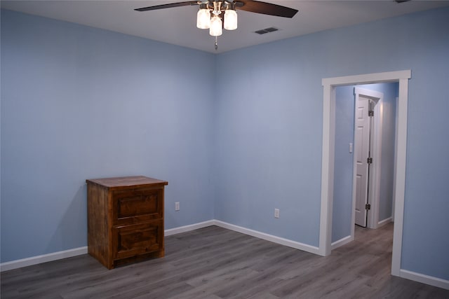 spare room featuring dark hardwood / wood-style flooring and ceiling fan