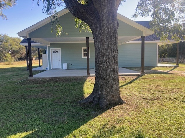 rear view of property with a yard