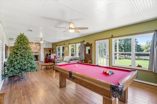 game room featuring pool table, hardwood / wood-style floors, ceiling fan, and a fireplace