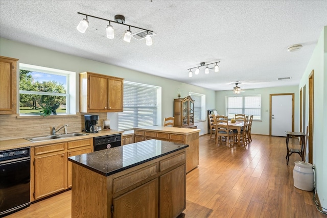 kitchen featuring a center island, plenty of natural light, backsplash, and ceiling fan