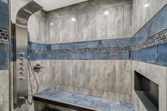 bathroom with tile walls and tiled shower