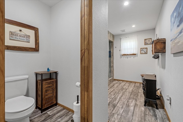 bathroom featuring toilet and hardwood / wood-style flooring