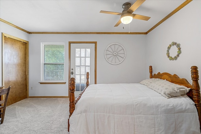 carpeted bedroom featuring ceiling fan and crown molding