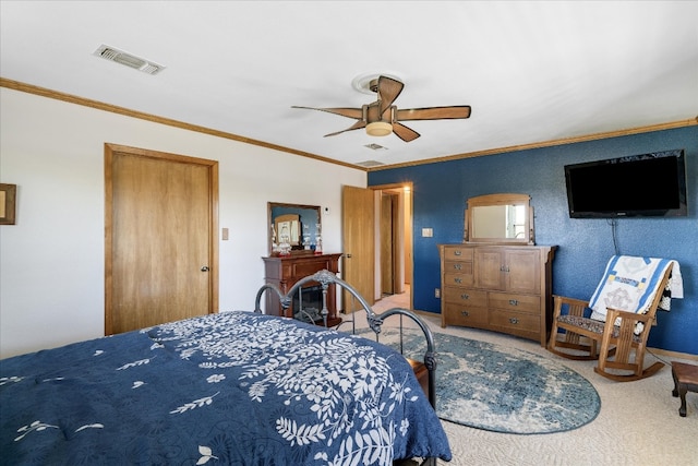 carpeted bedroom with ornamental molding, a closet, and ceiling fan