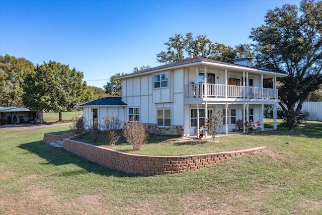 exterior space with a balcony and a lawn