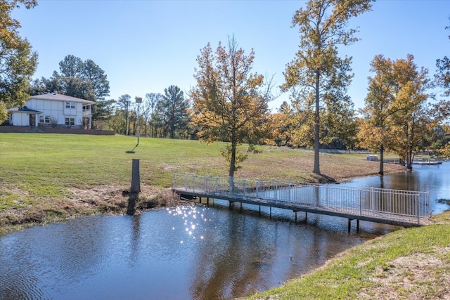 dock area featuring a yard and a water view