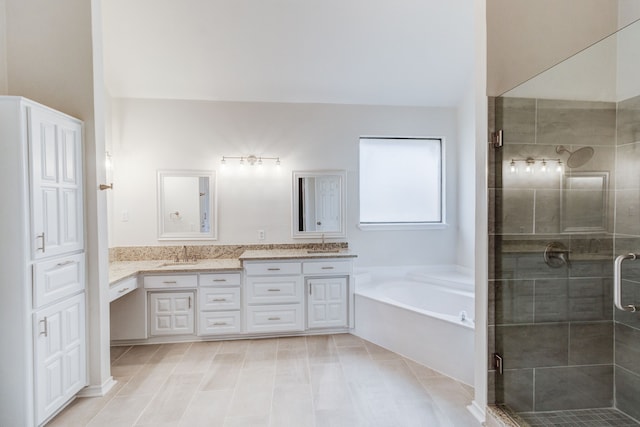 bathroom featuring dual vanity, shower with separate bathtub, and tile patterned floors