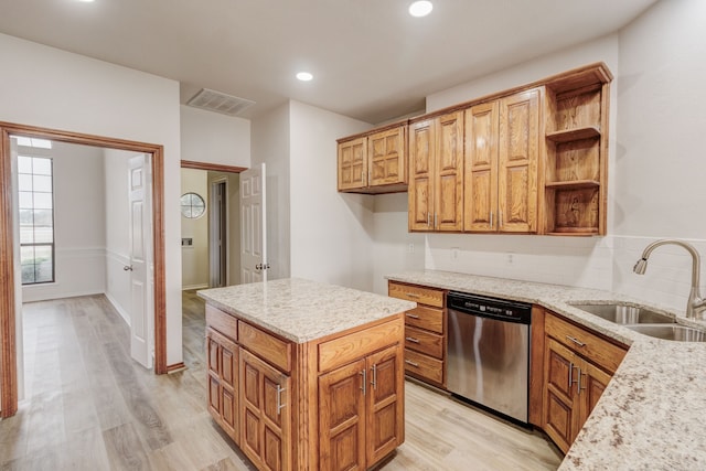 kitchen featuring sink, dishwasher, light wood-type flooring, and backsplash