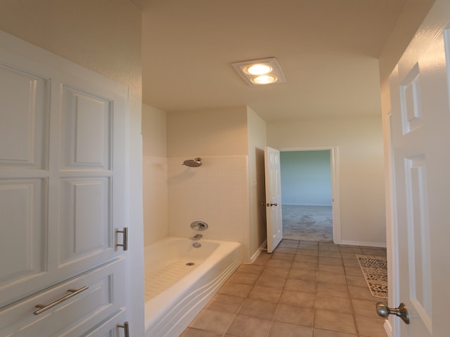 bathroom featuring tile patterned flooring and tiled shower / bath