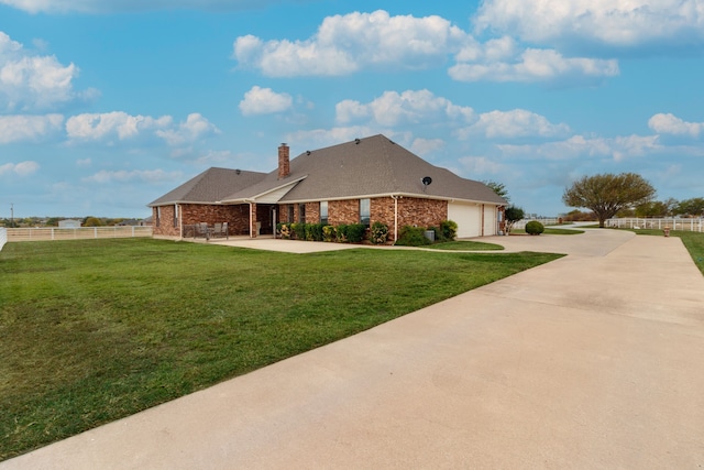 view of front of house featuring a garage and a front lawn