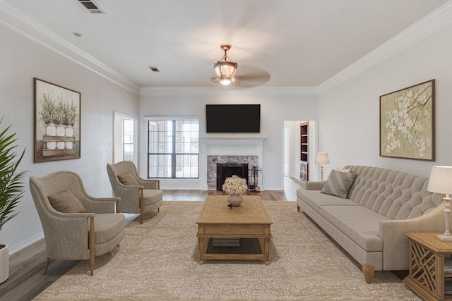 living room featuring ceiling fan, hardwood / wood-style flooring, and ornamental molding