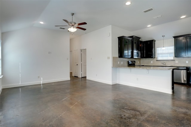 kitchen with backsplash, lofted ceiling, stainless steel appliances, and ceiling fan