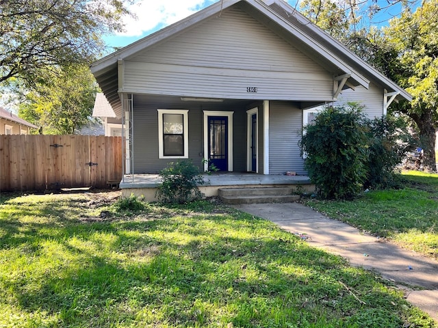 bungalow-style home featuring a porch and a front yard