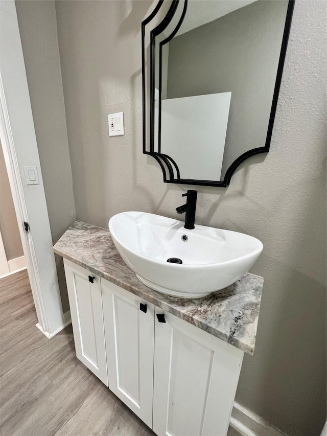 bathroom featuring hardwood / wood-style flooring and vanity