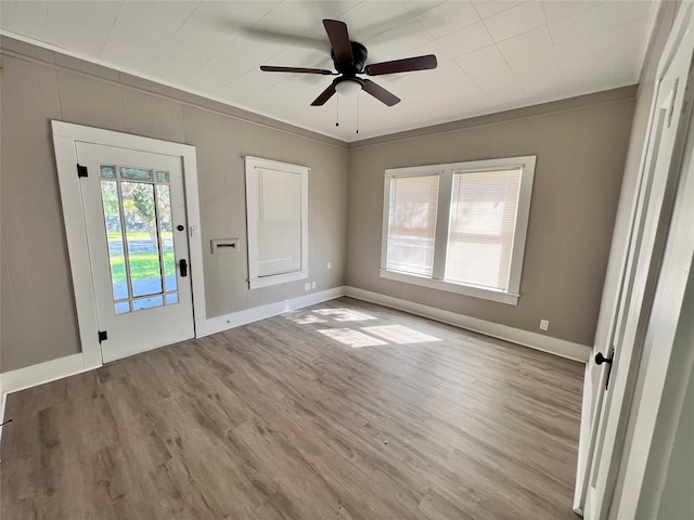 empty room with crown molding, ceiling fan, and light hardwood / wood-style floors