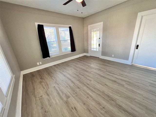 unfurnished room with ceiling fan and light hardwood / wood-style flooring