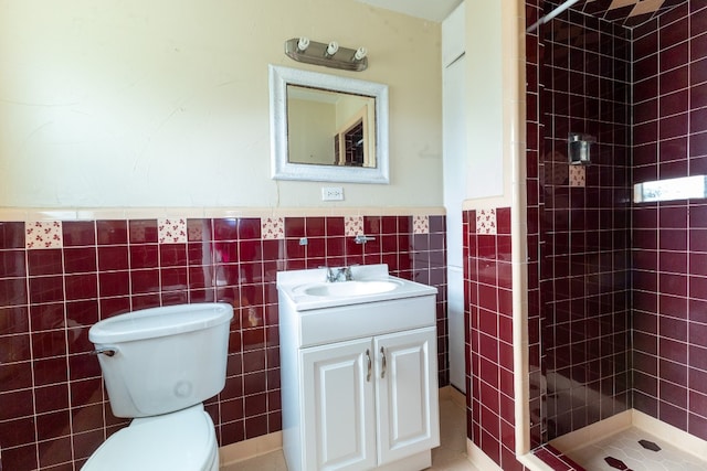 bathroom with oversized vanity, tile walls, toilet, and tiled shower