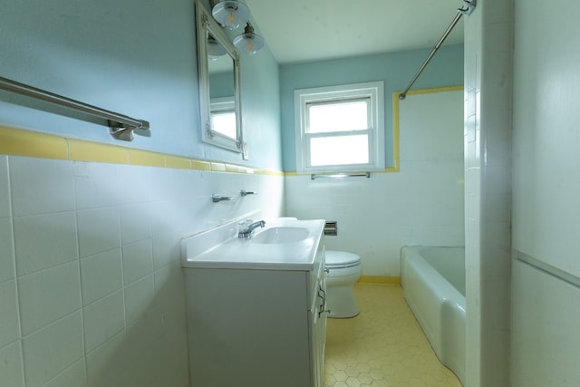 full bathroom with bathing tub / shower combination, tile walls, tile flooring, toilet, and oversized vanity