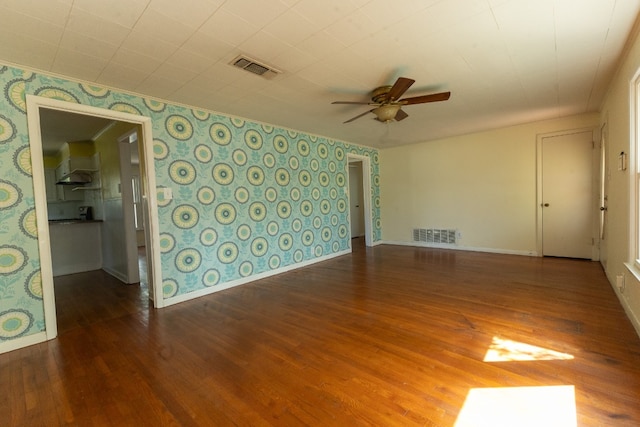 unfurnished room with ceiling fan and dark wood-type flooring