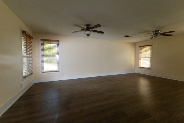 unfurnished room with dark hardwood / wood-style floors and ceiling fan