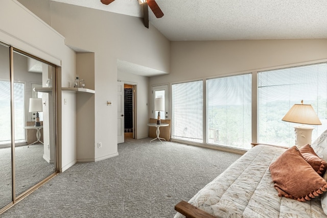 bedroom featuring ceiling fan, lofted ceiling, a textured ceiling, and carpet flooring