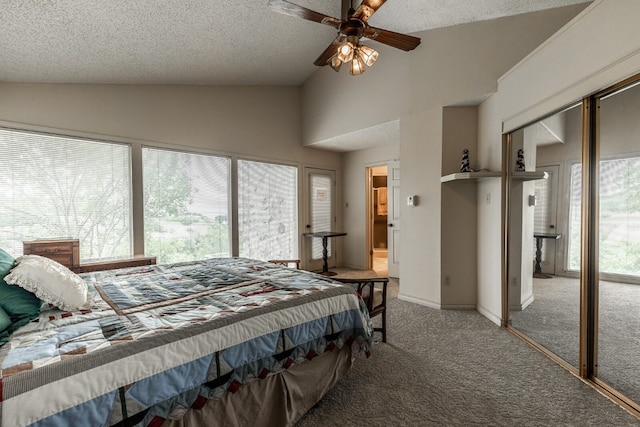 carpeted bedroom featuring multiple windows, a textured ceiling, lofted ceiling, and ceiling fan