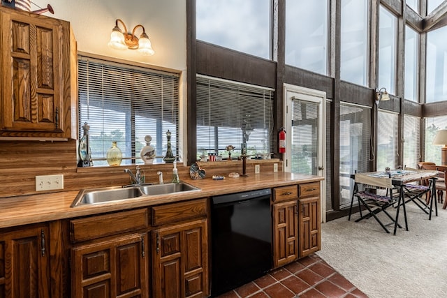 kitchen featuring sink, dishwasher, and dark tile floors