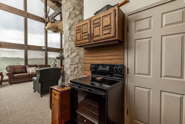 kitchen featuring light carpet and black electric range oven