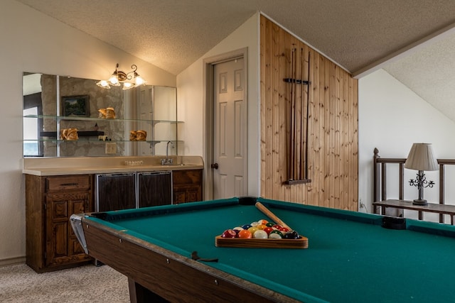 game room featuring billiards, wooden walls, a textured ceiling, and light colored carpet