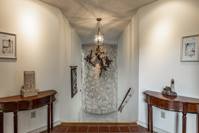 foyer with tile flooring and a textured ceiling