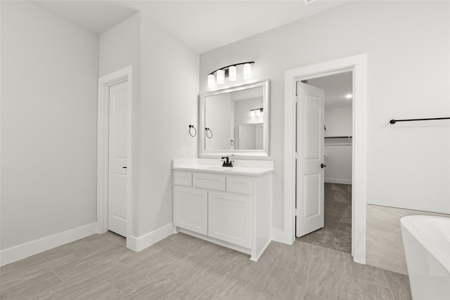 bathroom featuring vanity and a bath