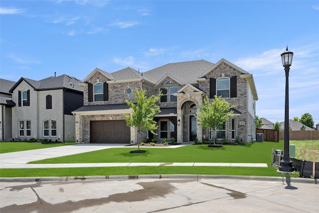 french country style house featuring a front yard and a garage