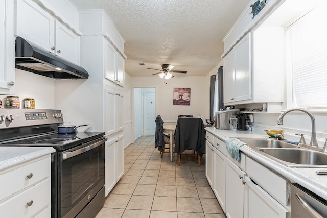 kitchen with ceiling fan, stainless steel appliances, light tile floors, and white cabinets