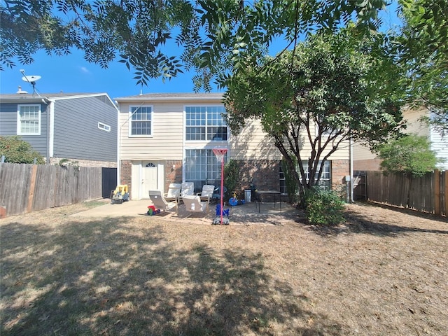 back of property featuring a yard and a patio area