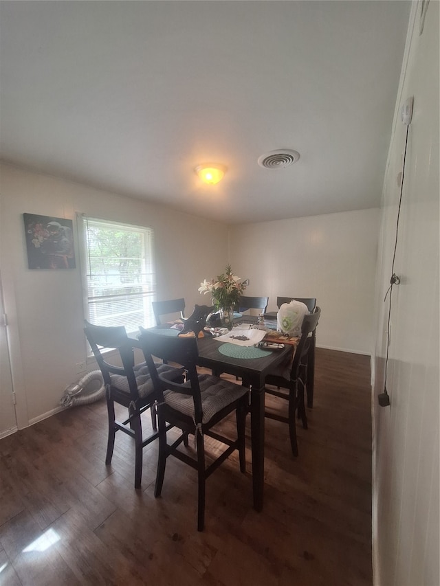 dining area with dark wood-type flooring