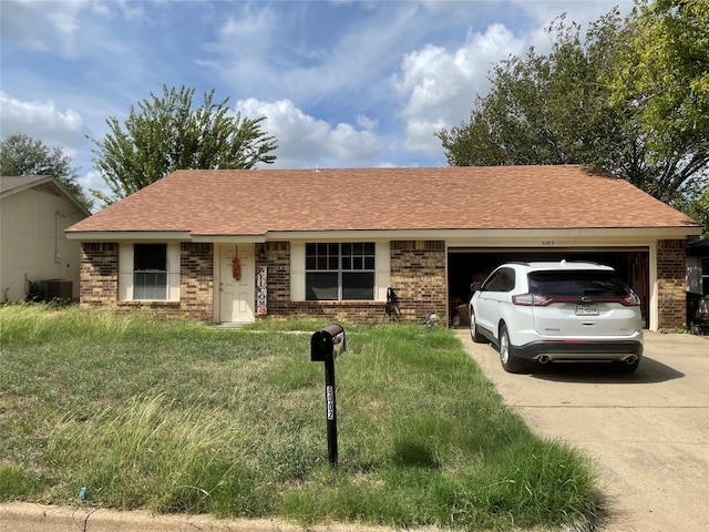 single story home featuring a front yard, central AC, and a garage